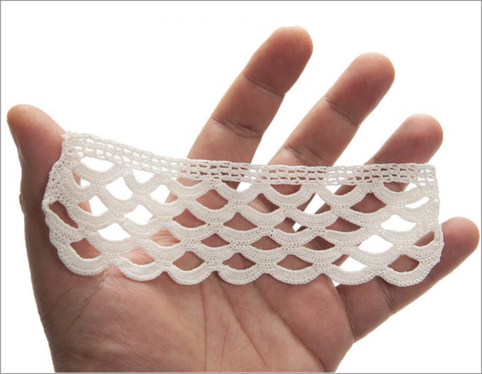 The top part of the lace is crocheted by the double crochet technique as a band. The hanging bottom area is crocheted one under another as 5 rows to create asymmetrical waves vertically.