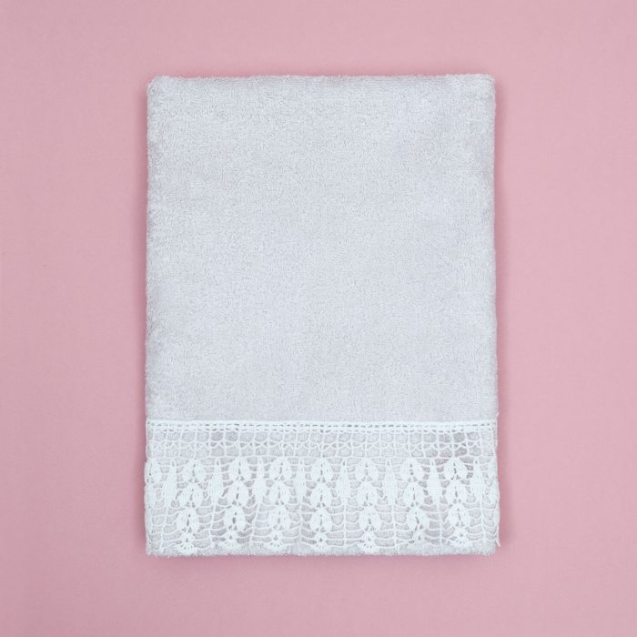 Light purple color towel has white crochet design for the bottom part and also edge crocheting for the rest 3 edges.