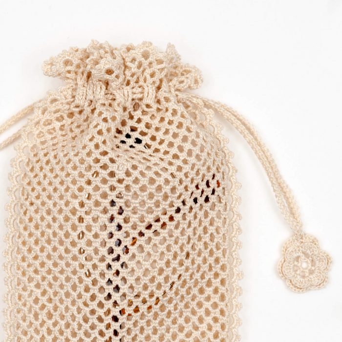 Crochet Soft Drawstring Style Sunglass Pouch With Dotted Textured Close Body Shot Glass Is Inside