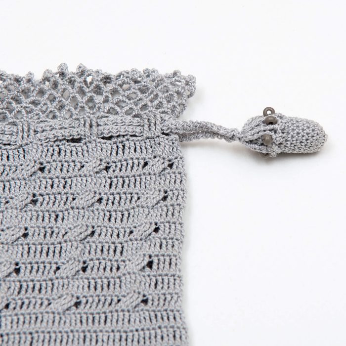 Gray Crochet Case With Tiny Crochet Flowers Small Sand Beads Tassel Angle Shot