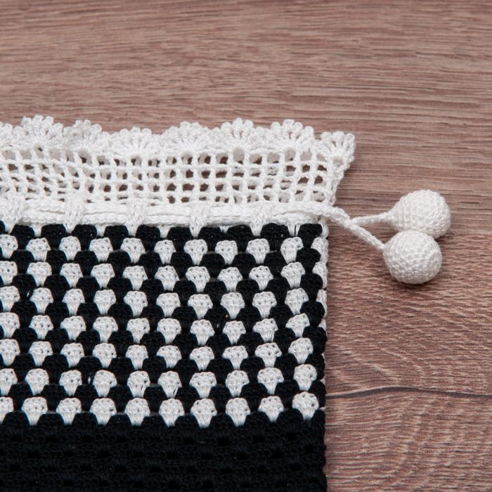 Handmade Crocheted Bicolor Case With Spotted Textured Body And Twin Tassel Close Shot