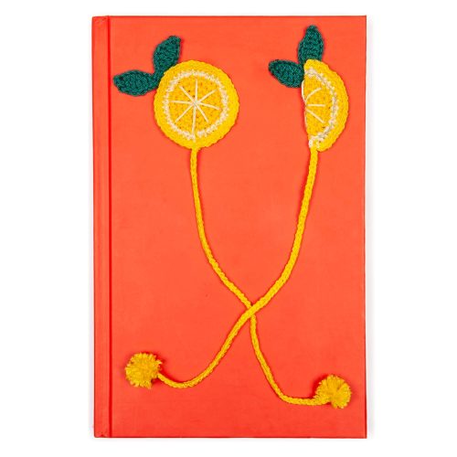 Cottagecore-inspired Crochet Lemon Slice Bookmark with Pom-Pom Tassel On The Book Shot