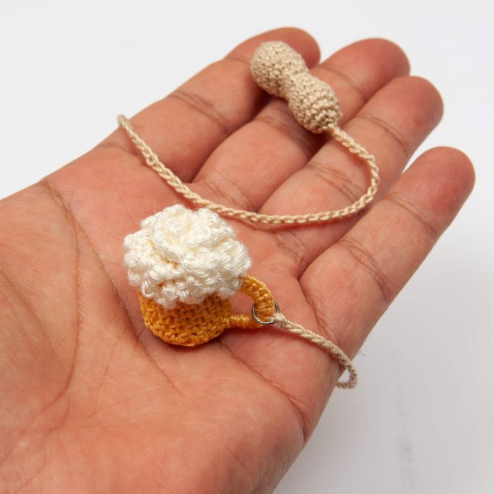 Crochet Handmade Beer Glass With Crochet Peanut Tassel Detail Inside The Hand Shot
