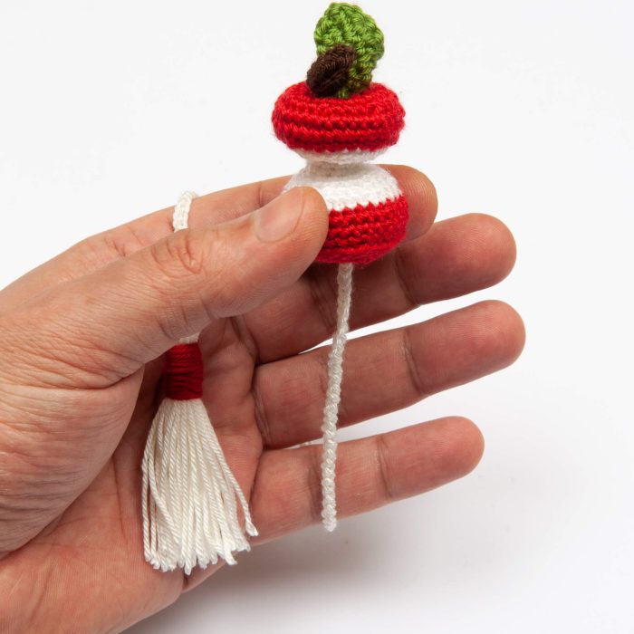 Handmade Amigurumi Crocheted Eaten Apple Bookmark With Tassel Inside Hand Close Shot